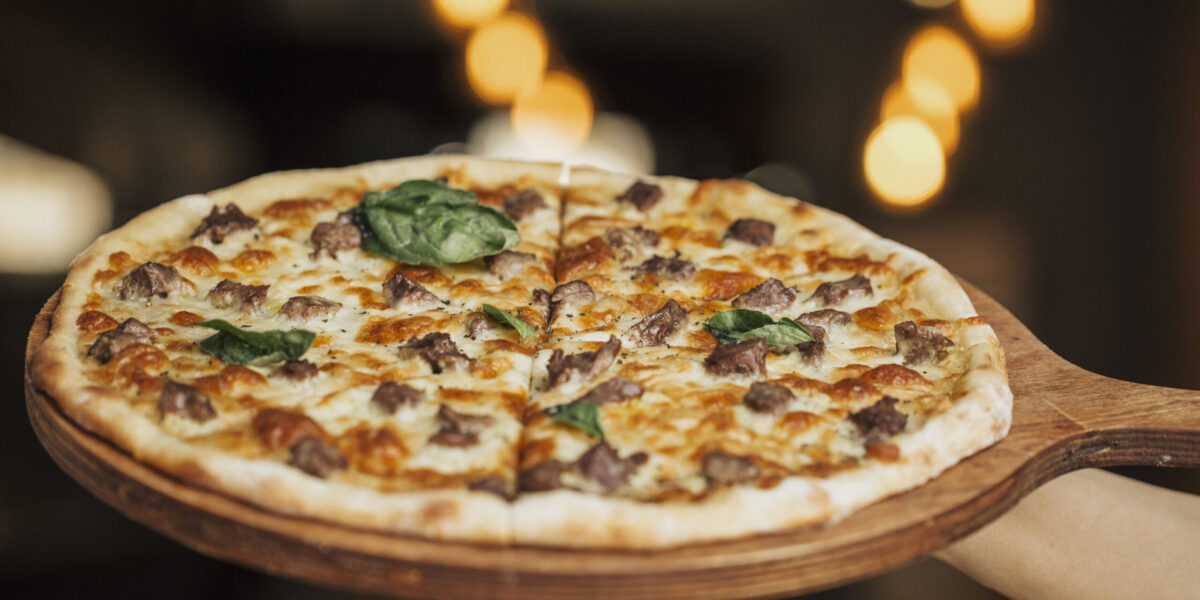 Mixed ingredient pizza on a wooden board